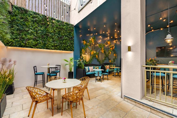Enclosed courtyard a the Morgan hotel with table and chair perfect for spring and summer dining
